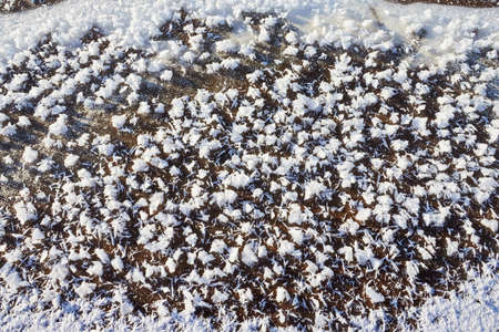 Testure or background with snow, ice and sand in a cold winter day outdoors. Nature landscape with...