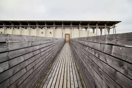 Vardo, Norway - 23 June 2019: Memorial devoted to memory innocently killed during witch hunting. Long building with small window with lamps and signs about executed and burned at stake womenのeditorial素材