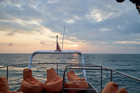 View from the ship on the water of sea and sky with clouds and sunset