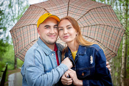 Kirov, Russia - June 22, 2020: European couple of blonde woman and bald man walking at park,...