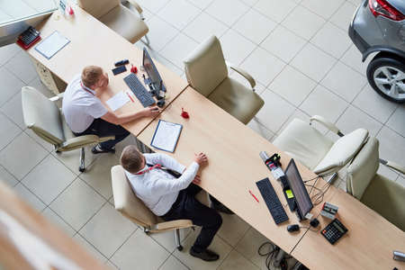 Vologda, Russia - June 18, 2019: Manager in showroom with cars of dealership Nissan in Vologda city in Russiaのeditorial素材