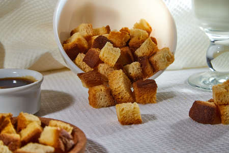 Square toasted pieces of homemade delicious rusk, hardtack, Dryasdust, zwieback in a plate on a...