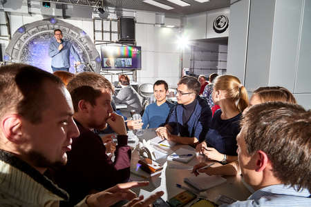 Kirov, Russia - September 25, 2019: People at table in small cafe or restaurant during intellectual game. Hungry group waiting for the waiter to get the menu or foodのeditorial素材