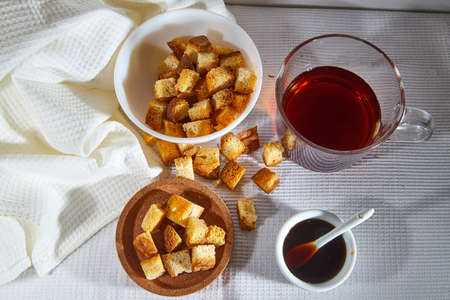 Square toasted pieces of homemade delicious rusk, hardtack, Dryasdust, zwieback, Liquid honey in a...