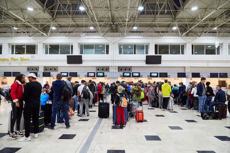 Antalya, Turkey - December 21, 2019: Large hall at the airport and passengers are waiting in line...