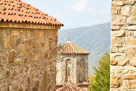 Orthodox church in Jvari Monastery located near Mtskheta, Georgia. Old house built of yellow stones and bricksの写真素材