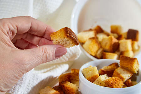 Square toasted pieces of homemade delicious rusk, hardtack, Dryasdust, zwieback in a plate on a...