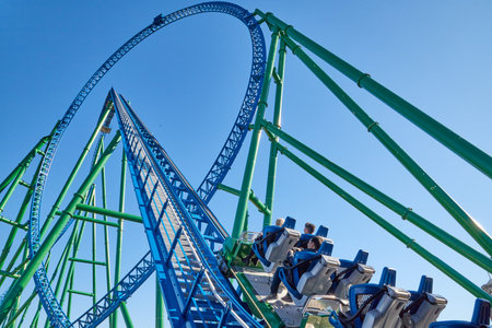 Belek, Turkey - December 17, 2019: Roller coaster Ride against blue sky in a nice day and people in the trailer getting funのeditorial素材