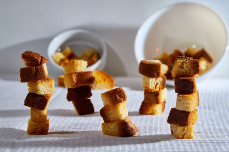 Square toasted pieces of homemade delicious rusk, hardtack, Dryasdust, zwieback stand in columns...