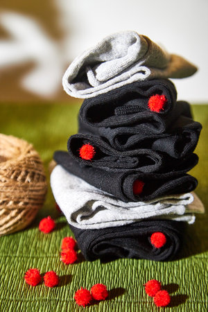 Several pairs of male socks on a green surface