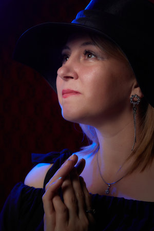 Portrait of fat plump chubby middle-aged woman with hat and black dress. Model looking as lady...