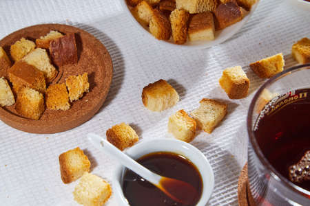 Square toasted pieces of homemade delicious rusk, hardtack, Dryasdust, zwieback, Liquid honey in a...