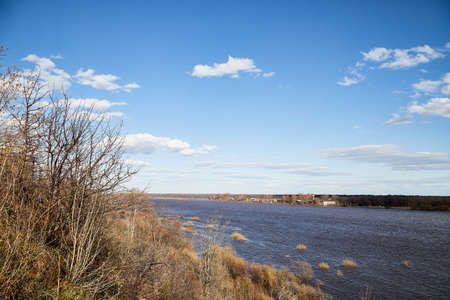 High water on a river or on a lake in sunny spring day. Russian nature landscape with water, trees...