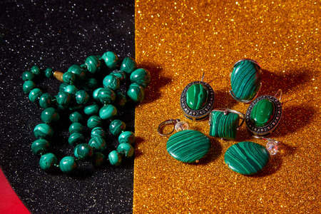 Jewelry from green malachite. Malachite beads and earrings in the studioの写真素材