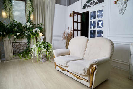 Living room with beautiful interior, sofa and flowersの写真素材