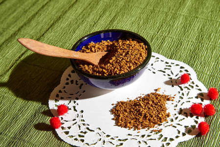 Loose instant coffee in blue beautiful ceramic saucer and a small wooden spoon. Resource for making a delicious coffee drinkの写真素材