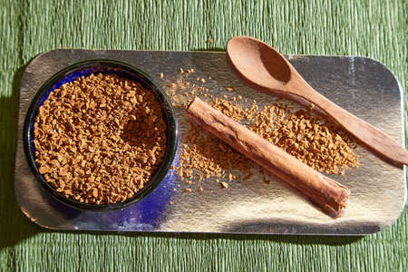 Loose instant coffee in blue beautiful ceramic saucer and a small wooden spoon. Resource for making a delicious coffee drinkの写真素材