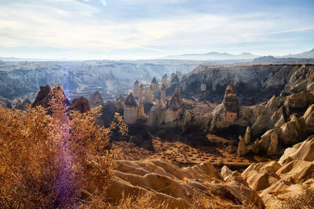 View from top place on the strange landscape in the Cappadocia valley with yellow mountains, rocks...