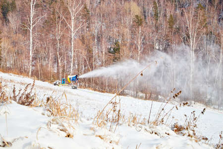 Snow cannon preparing a slope to ski seasonの写真素材