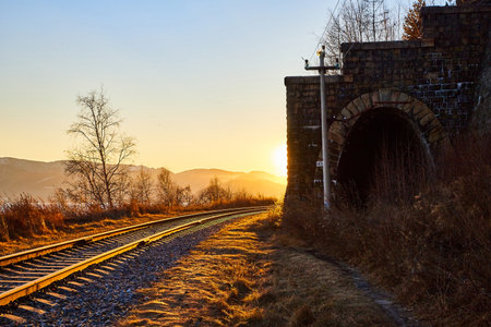 Tunnel on Circum Baikal railway running along the shore of Lake Baikal on an autumn sunny day with a...