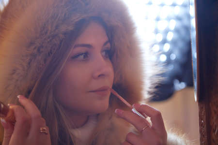 A portrait of a beautiful girl wearing a fur coat. Beauty, winter fashionのeditorial素材