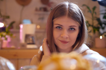 Girl with long hair in a room with a lot of things. Portrait of a young woman in cozy house