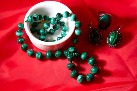 Jewelry from green malachite. Malachite beads and earrings in the studioの写真素材