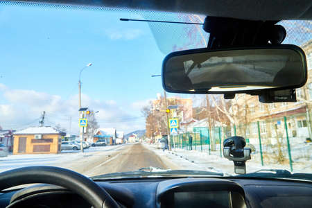 listvyanka baikal, russia - November 19, 2020: View from the driver's side of car interior to city ahead through the windshieldのeditorial素材