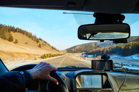 Siberia Baikal, Russia - November 20, 2020: View from of car interior from side of driver to the...