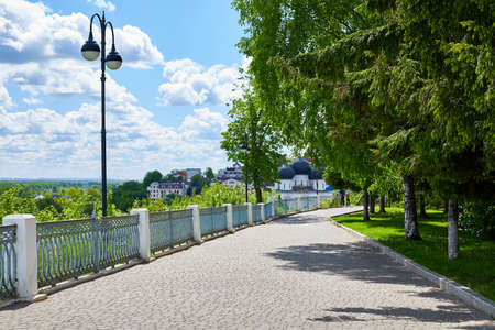 Kirov, Russia - May 28, 2020: Alley with a fence with white columns in a city park on a sunny summer dayのeditorial素材