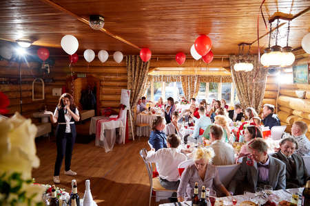 Kirov, Russia - June 20, 2020: People at the table in a restaurant during a banquet at a traditional Russian wedding. Guests celebrate wedding in Russiaのeditorial素材