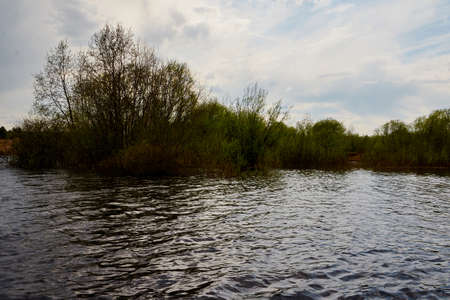 Water of a river or lake during flood on an early spring dayの写真素材