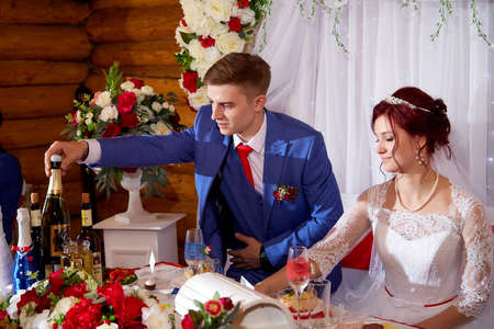 Kirov, Russia - June 20, 2020: Newly married couple at the wedding Banquet at the richly laid table. Russian traditional holiday with bride and groomのeditorial素材
