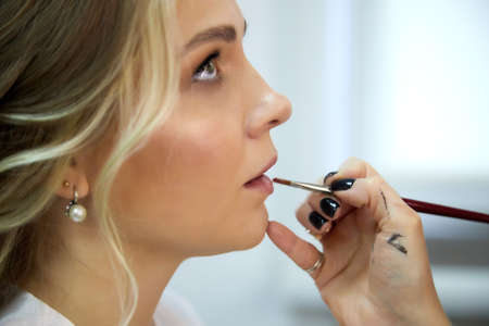 Bautiful bride in the morning with a hairstyle makeup after a visit to a makeup artist and stylist