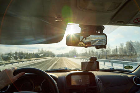 Siberia, Russia - November 28, 2020: View from of car interior from side of driver to the road and...