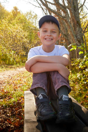Kirov, Russia - September 27, 2020: Handsome caucasian young boy in an autumn park with yellow leaves. Childhood conceptのeditorial素材