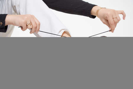 Black female or male patent leather shoes on legs of woman. Shooting for catalog or an online store. A pair of shoesの写真素材