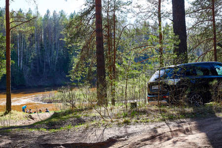 Kirov, Russia - May 09, 2020: Car and people on vacation in the forest on a sunny summer or spring...