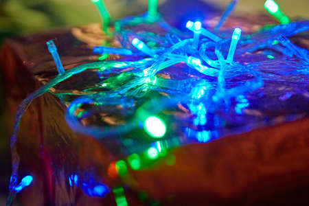 Christmas lights in dark room. Lights at Christmas and New Year indoorsの写真素材