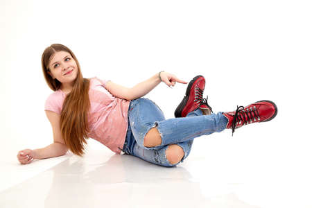 Beautiful young woman or girl wearing casual clothes on white background. Young female model posing during photo shootの写真素材