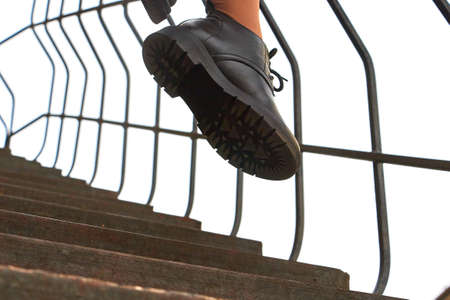Black female or male leather shoes on legs of woman. Shooting for catalog or an online store...