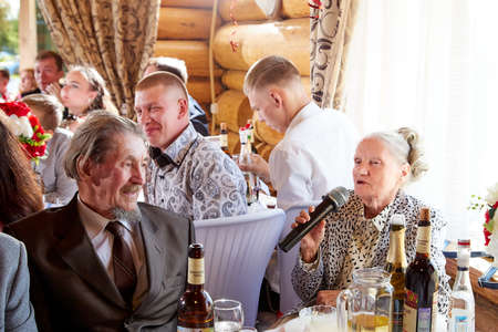 Kirov, Russia - June 20, 2020: People at the table in a restaurant during a banquet at a traditional Russian wedding. Guests celebrate wedding in Russiaのeditorial素材