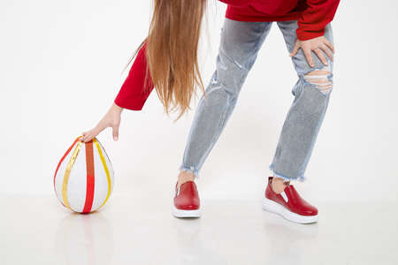 Red beautiful fashionable female loafers shoes on leg of girl or woman. Studio shoot on white background for magazine, website in Internet or catalogの写真素材
