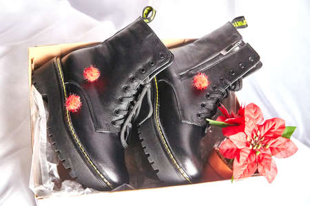 Female winter, autumn or spring black leather shoes in studio. Fashionable modern photography for a...