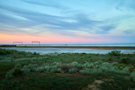 Landscape with lake, steppe, grass and blue sky with clouds in autumn or summer eveningの写真素材