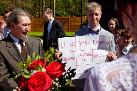 Kirov, RUSSIA - June 20, 2020: Wedding Event. Bride and Groom and guests and relatives meeting them outdoors in beautiful sunny summer day. Traditional wedding ceremony in Russiaのeditorial素材