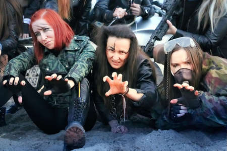 Kirov, Russia - September 11, 2021: Post apocalyptic crowd of woman with weapons outdoor. Attractive...