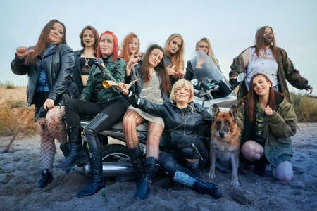 Kirov, Russia - September 11, 2021: Post apocalyptic crowd of woman with weapons outdoor. Attractive strange fighter girl warrior in shabby clothesのeditorial素材