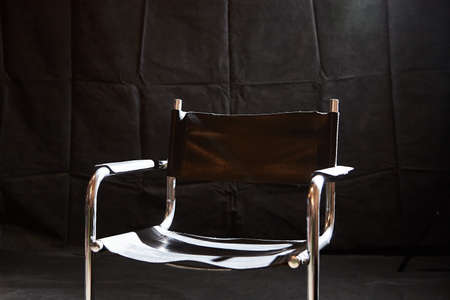Director's chair in dark place with black background. location photo shootの写真素材