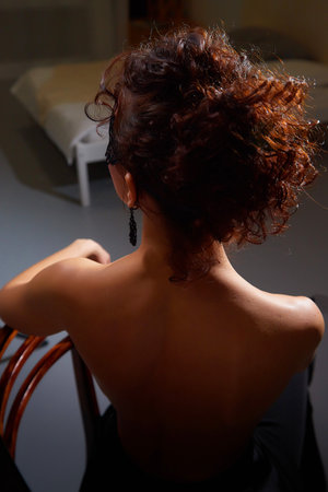 Mysterious brunette girl in black mask with bare back. Model posing in studioの写真素材